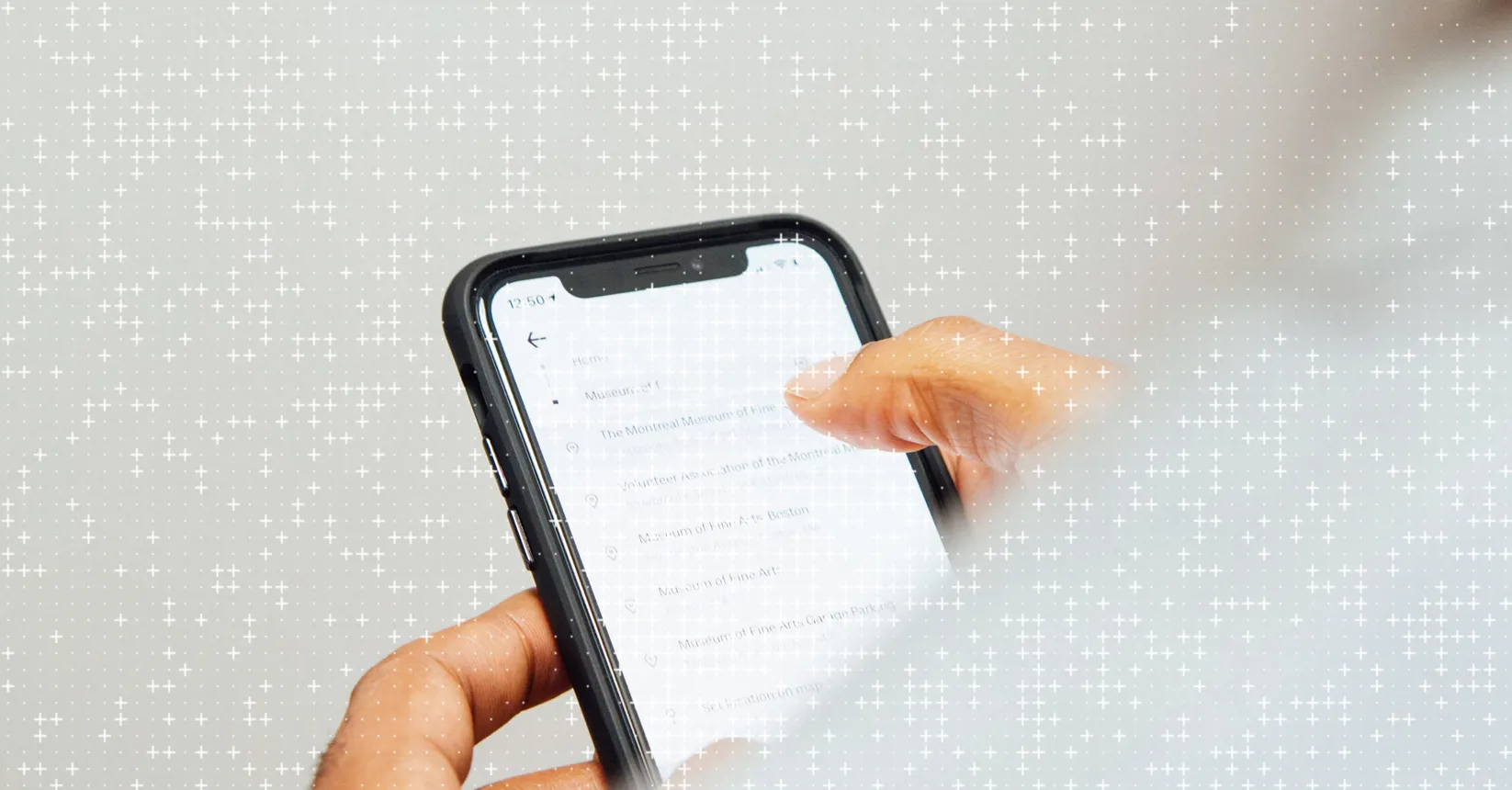 A hand holding a phone, reading a message